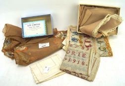 A collection of needlework, including two alphanumeric samplers, an ebroidered table runner,