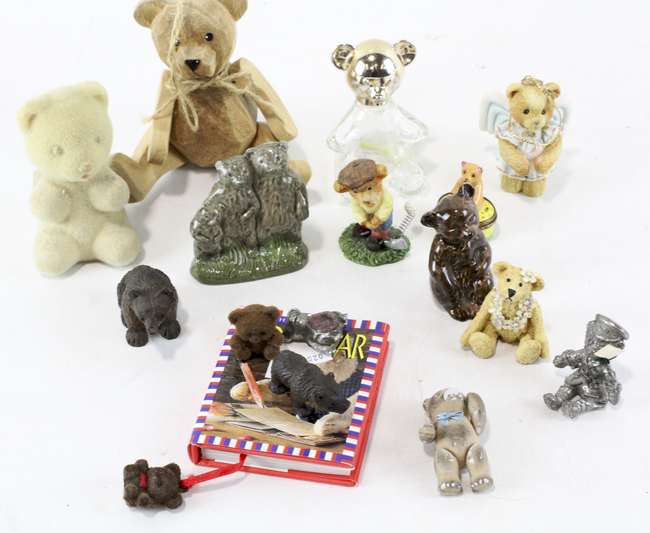 A group of small teddy bear collectables, including two black forest carved wooden figures, and more