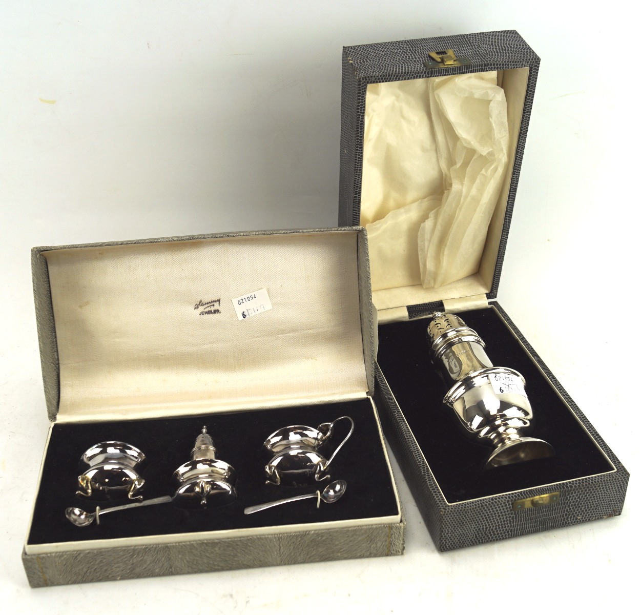 A silver sugar sifter in box and condiments,
