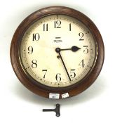 A Smiths 8 day wall clock in an oak case, Arabic numerals denoting hours to the face,