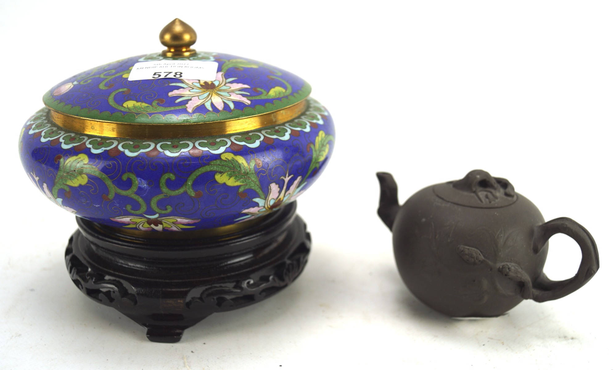 A contemporary cloissonne enamel lidded pot on stand and a teapot, the pot decorated with flowers,