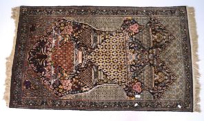 A silky black ground rug woven with baskets of flowers