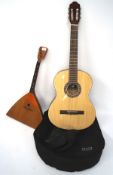 A CC44 classical guitar and another smaller stringed instrument, the guitar with a case,