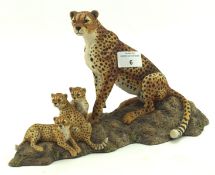 A Border ceramic sculpture of a cheetah family, on naturalistic base,