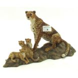 A Border ceramic sculpture of a cheetah family, on naturalistic base,