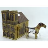 A DRGM German tin plate musical Cathedral and clockwork dog, both with lithoprint decoration,