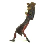 A cast metal figure of a gentleman wearing a hat and carrying a bag, painted,