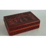 A small 19th/20th century Chinese red lacquer box carved with figures in a landscape