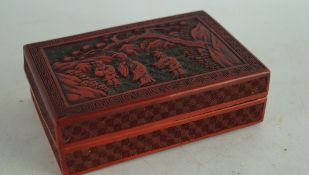 A small 19th/20th century Chinese red lacquer box carved with figures in a landscape
