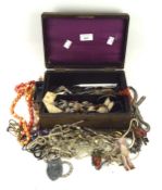 A vintage jewellery box containing a selection of costume jewellery,
