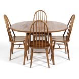 An Ercol blonde elm and beech drop leaf dining table and four hooped spindle back dining chairs,