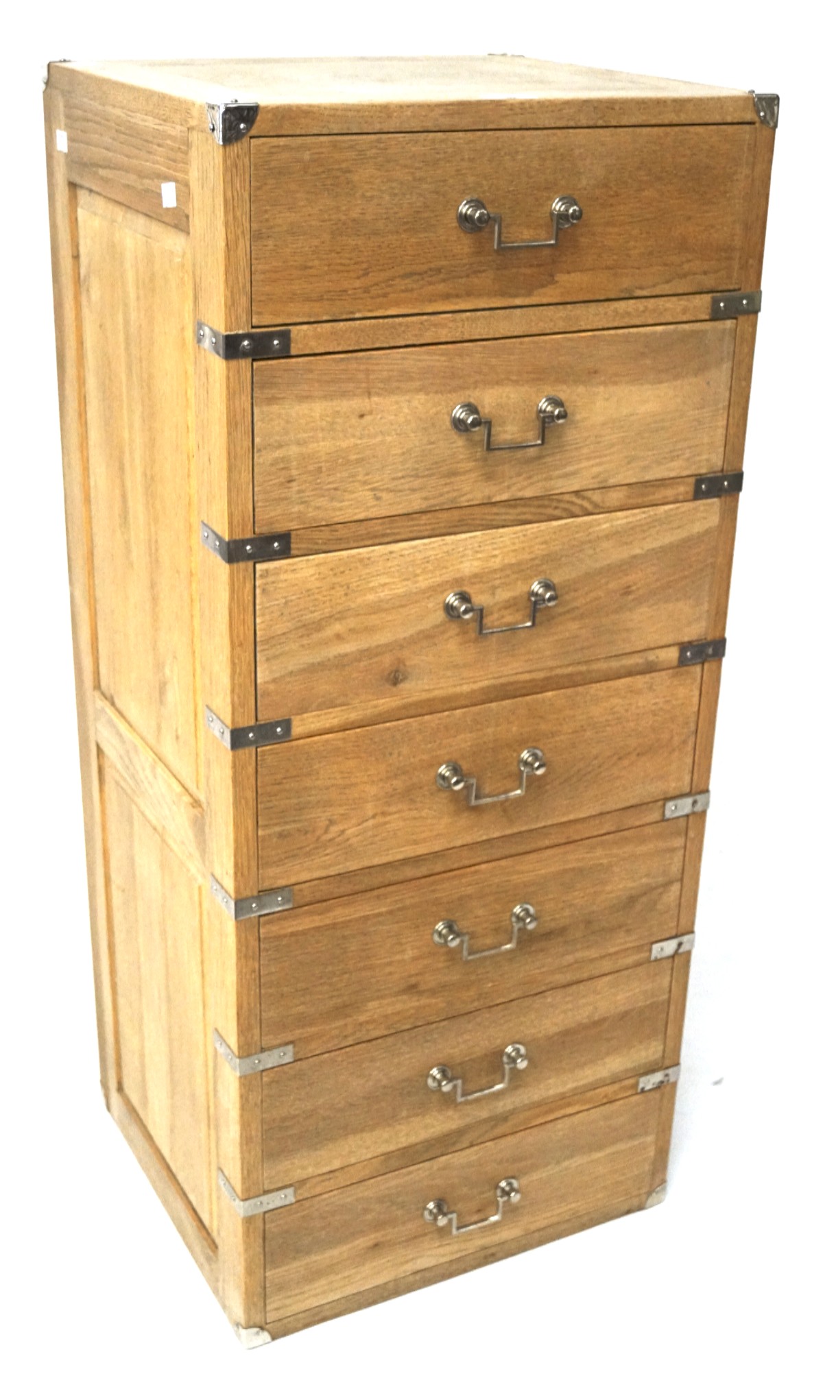 A contemporary oak tall narrow chest of drawers mounted white metal in the campaign style,