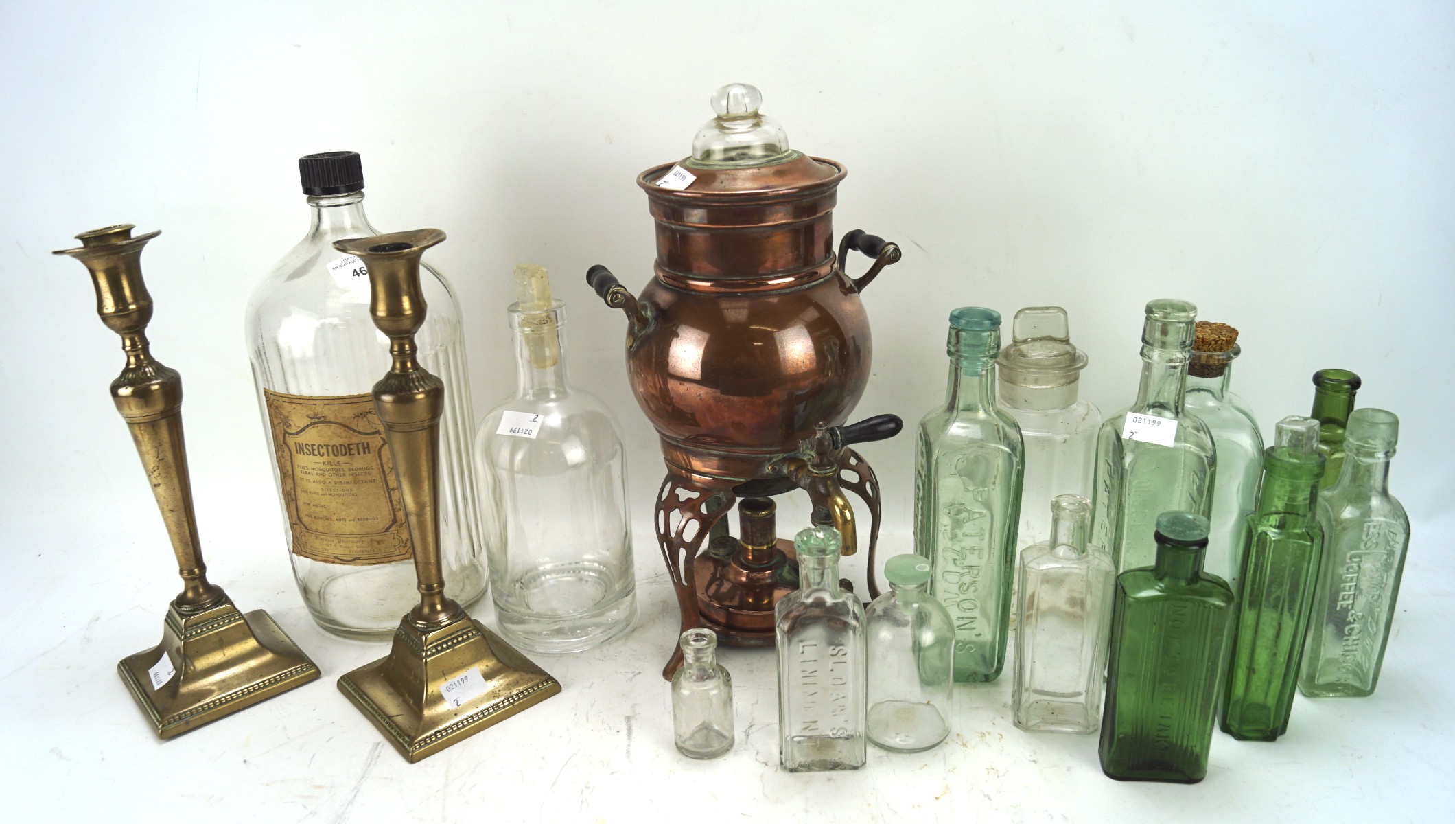 An assortment of mixed collectables, including a pair of 19th century brass candlesticks,