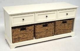 A contemporary white side unit, three short drawers above three wicker baskets,