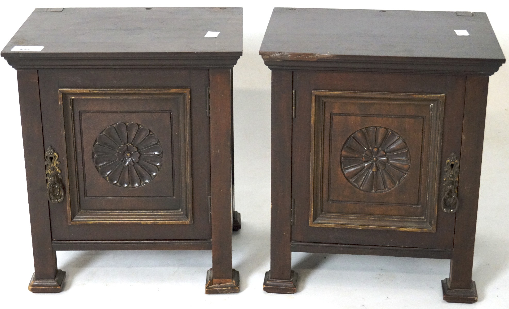 A pair of small wooden cupboards, both with panelled doors carved with flowers L30.5cm x D23.