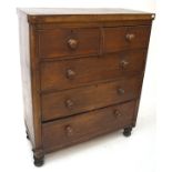 A late 19th century mahogany chest of two short over three drawers, with turned handles,