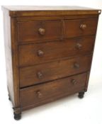 A late 19th century mahogany chest of two short over three drawers, with turned handles,