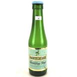 A vintage green glass Babycham bottle, with cap and original label,