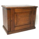 A 20th century small oak cabinet, of rectangular form with a bevelled panel to the door,
