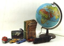 A collection of toys, including a desktop revolving atlas lamp,