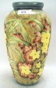 A contemporary tube lined pottery vase in the Moorcroft style.