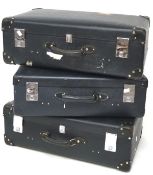Three vintage Globetrotter suitcases, in black with leather handles,