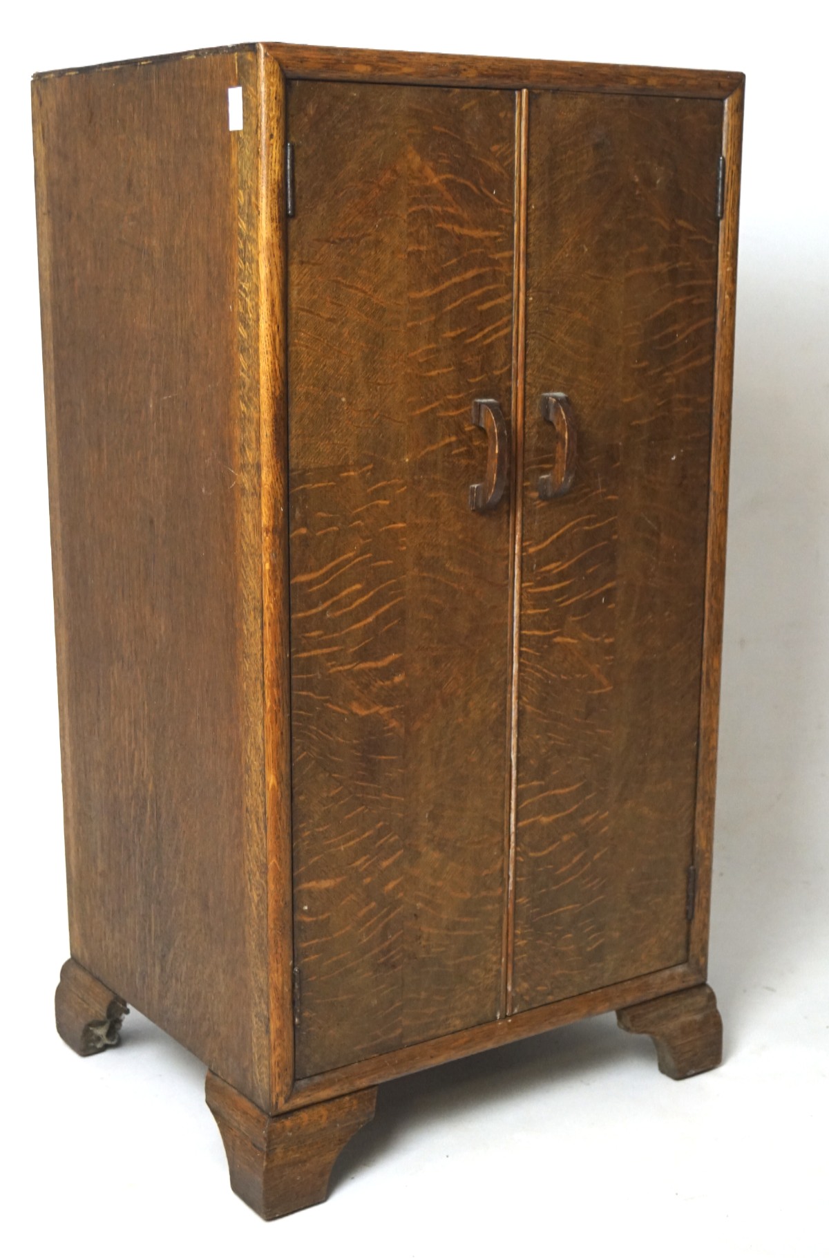 A 20th century oak two door cabinet, containing a single shelf, on bracket supports, L42cm x D35.