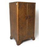 A 20th century oak two door cabinet, containing a single shelf, on bracket supports, L42cm x D35.
