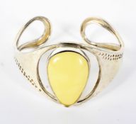 A silver (unmarked) and lemon amber set bangle, weight 27.