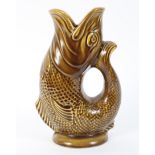 A vintage mustard glazed Dartmouth pottery gluggle jug, in the form of a fish,