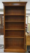 A large 20th century mahogany veneer bookcase, with four adjustable shelves,