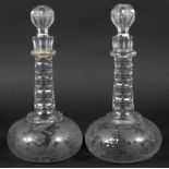 A fine pair of matched glass decanters decorated with birds, grapes and vines,