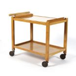 A beech effect two tiered push along tea trolley, with a lift out twin handled glass tray,