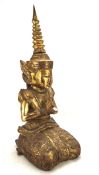 A 20th century giltwood figure of a Thai buddha, kneeling in a position of prayer,