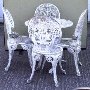 A cast aluminum white painted garden table and four chairs,