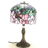 A Tiffany style dragonfly table lamp, on a simulated patinated bronze foliate cast base,