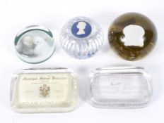 Five paperweights including mid-century advertising examples, a Wedgwood Silver Jubilee example,