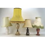 An assortment of table lamps, with stone and simulated stone bases, with assorted shades,