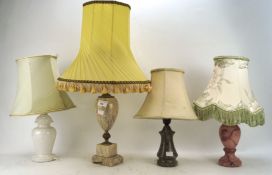 An assortment of table lamps, with stone and simulated stone bases, with assorted shades,