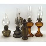 Four late 19th/early 20th century small oil lamps, including a pair of orange glass examples,