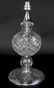 A contemporary Irish Galway crystal table lamp, with bulbous central section and chrome fittings,