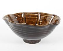 A 20th century brown glazed bowl, with fluted rim, marked 'JLJC' to base, diameter 21.