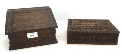 Two carved wooden boxes, the first an Indian box carved with dense vine and a temple, 20 cm long,