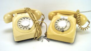 Two vintage cream coloured telephones, with plastic case and traditional dial,