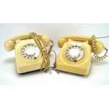Two vintage cream coloured telephones, with plastic case and traditional dial,