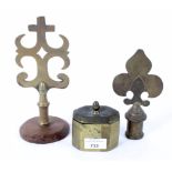 Two brass staff finials and a tobacco box, the finials in the Gothic style,