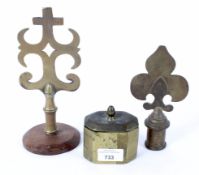 Two brass staff finials and a tobacco box, the finials in the Gothic style,