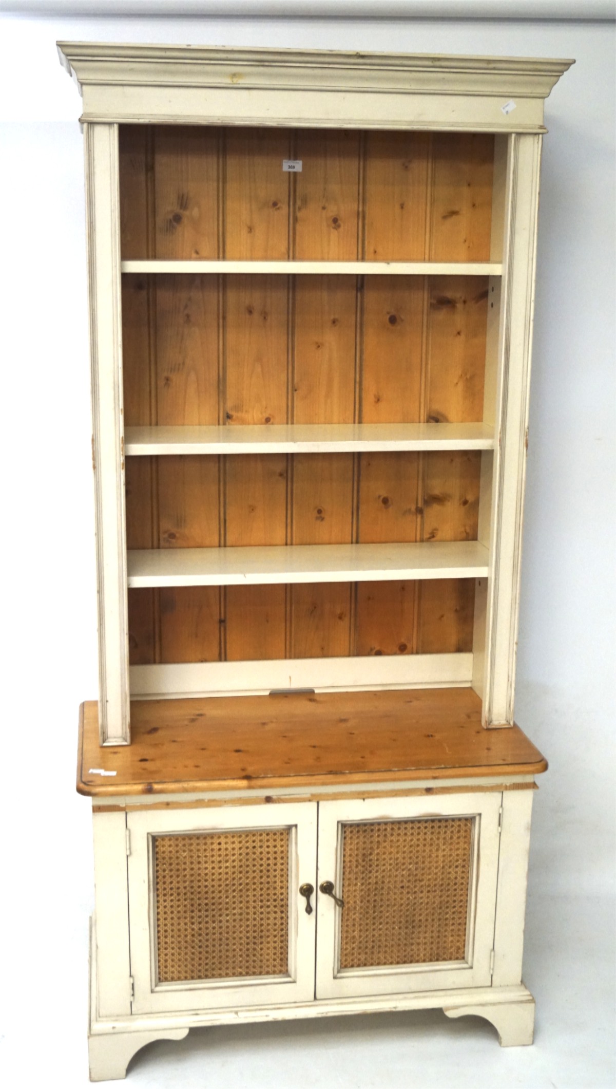 A painted pine dresser, with three adjustable shelves above caned double door cupboard,