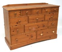 A modern pine chest, with thirteen drawers in sizes,