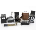 An assortment of vintage cameras, including a Kodak 'Brownie' 120,